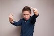 A boy shows middle fingers to the camera