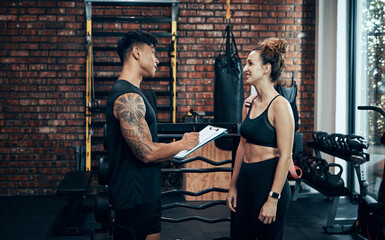 Aufkleber - Signup with us, you wont regret it. Shot of a sporty young woman talking to a fitness trainer at the gym.