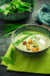Homade bear leek soup or ramson soup with crouton and sour cream