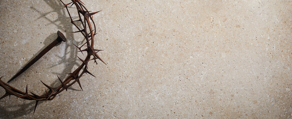 Wall Mural - Easter concept. Crown of thorns with Nail on a stone background.