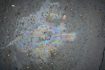 Oil slick on the asphalt road background