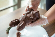 Hands Of A Female Chocolatier Preparing An Easter Filled Chocolate Bunny