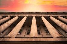 Classical Columns On Government Building With Colorful Sky