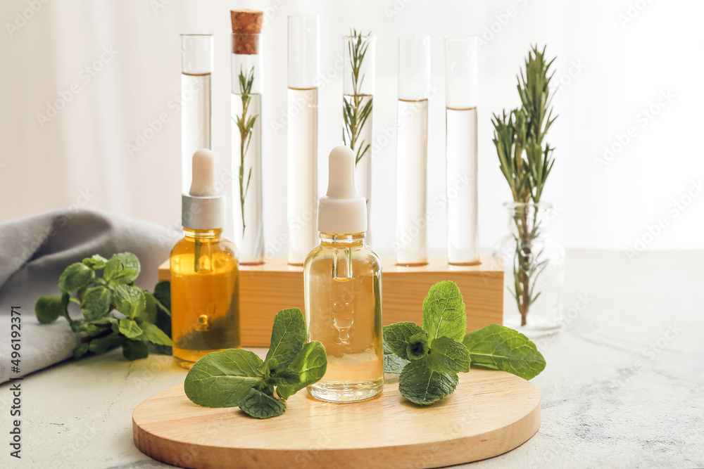 Bottle of natural mint oil on table in laboratory