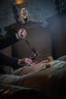 FRANCE, GIRONDE, SAINT-EMILION, SAMPLING A GLASS OF WINE IN A BARREL WITH A PIPETTE FOR TASTING AND VINIFICATION MONITORING