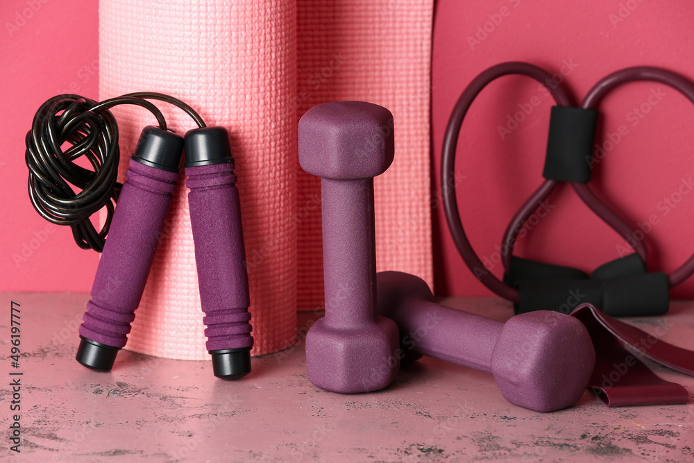 Stylish sport equipment on pink background