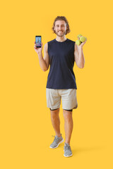 Sticker - Sporty man with phone and dumbbells on color background. Concept of online training