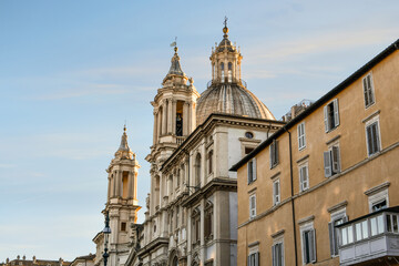 Wall Mural - The dome and towers of the Sant'Agnese in Agone, or St. Agnes Cathedral as the sun sets over the Piazza Navona in the historic center of Rome, Italy	