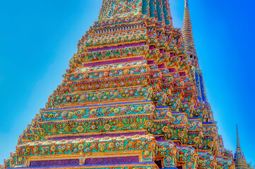 Colorful traditional decorations at Buddhist temple structures in Thailand.