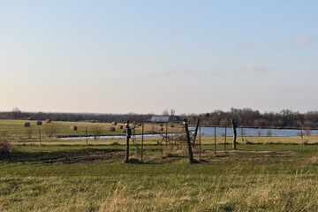 Poster - Garden with a Lake and Hay Bales in the Distance