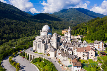 Wall Mural - Picturesque summer view from drone of alpine township of Re with pilgrimage church of Virgin Mary surrounded by green Alps, Piedmont, Italy