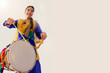 © IndiaPix - Portrait of Sikh woman playing drum during Baisakhi celebration