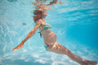 Pregnant woman exercise in outdoor pool underwater