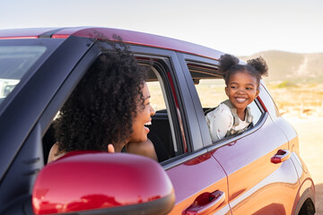 Wall Mural - Mother and black daughter peeping outside car