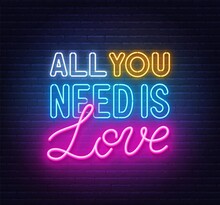 All You Need Is Love Neon Lettering On Brick Wall Background.