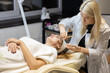© Ihor - Cosmetic facial skin care procedure in the cosmetologist's office for a woman