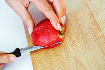 Fruit carving. The process of slicing an apple to create beautiful shapes and figurines. Close-up. Instruction