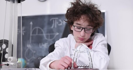 Wall Mural - schoolboy experimenting in physics class. young student doing physics experiment in the classroom