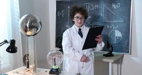 Wall Mural - a boy conducts physical experiments with electricity, a plasma ball, and a van de graaff generator.