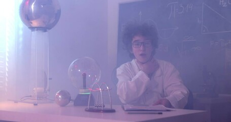 Wall Mural - schoolboy experimenting in physics class. young student doing physics experiment in the classroom.