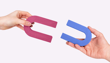 magnets in man and woman hands. love and relationship concept. symbol of magnetic attraction between