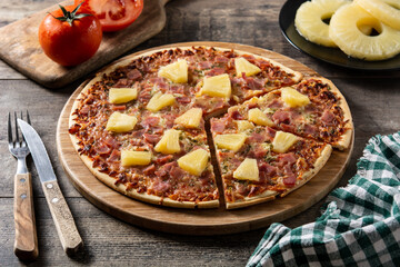 Wall Mural - Hawaiian pizza with pineapple,ham and cheese on wooden table	