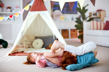 excited kids having fun at home. happy siblings playing at nursery room