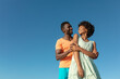 © wavebreak3 - Low angle view of smiling african american couple against clear blue sky with copy space