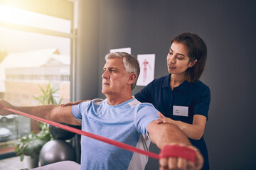 Aufkleber - And hold. Cropped shot of a young female physiotherapist treating a mature male patient.