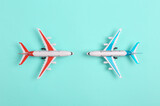 Fototapeta Boho - Two Toy model airplanes on blue background. Travel concept. Flat lay, top view