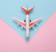 Toy Model Airplane On A Blue-pink Background. Travel Concept. Flat Lay, Top View