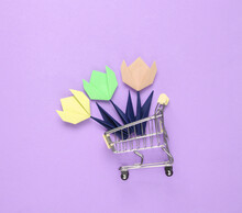 Origami Tulips Flower In Mini Shopping Cart On Purple Background.