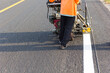 © anupan001 - Machine eject and worker on road and traffic sign painting