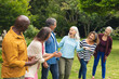 © WavebreakMediaMicro - Happy multiracial senior male and female friends having fun in backyard