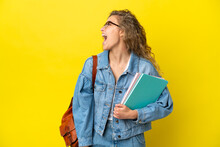 Young Student Caucasian Woman Isolated On Yellow Background Laughing In Lateral Position