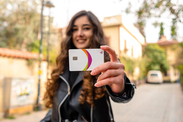 Credit card, happy attractive young woman holding and showing credit card.