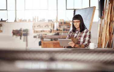 Poster - Shes in this game to create. Cropped shot of an attractive young woman working on her tablet while sitting in her creative workshop.