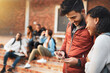 © Jadon Bester/peopleimages.com - Navigating campus life with a mobile app. Shot of a young man and woman using a mobile phone together on campus.