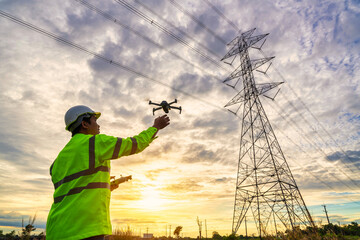 Wall Mural - asian engineers are launching drones to inspect the power station for a planned work by generating e