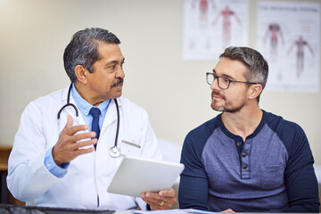 Aufkleber - Heres a a bit of advice you need to follow. Shot of a confident mature male doctor seated at his desk while consulting a patient inside a hospital during the day.