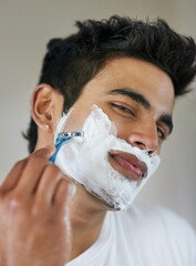 Poster - No shave November is done. Shot of a handsome young man shaving his facial hair in the bathroom.