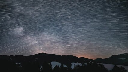 Wall Mural - star-trail comet effect of milky way galaxy star trails over forest astronomy time lapse 4k