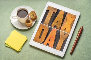 Wall Mural - tax day concept - text in vintage letterpress wood type on a digital tablet, flat lay with with coffee, financial concept