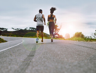 Poster - staying in top form together. rearview shot of a sporty young couple exercising together outdoors.
