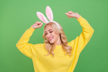 Wall Mural - Photo of pretty young blond lady dance wear ears yellow pullover isolated on green color background