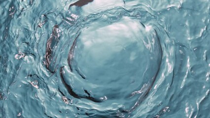 Wall Mural - Super slow motion of water surface on light blue background. Filmed on high speed cinema camera, 1000 fps.