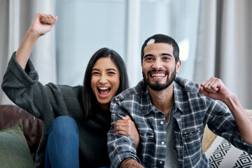 Poster - Who needs the local bar to have lots of fun. Shot of a happy young couple watching tv and cheering at home.