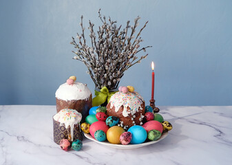 Canvas Print - Easter cakes (orthodox kulich), candle, colorful eggs and willow branches on table. Easter holiday Festive composition