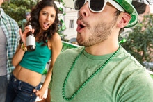Man Making A Face And Dancing With Friends While At St. Patrick's Day Party.