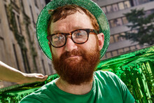 Redheaded Man Wearing Green Hat And Shirt At St Patrick's Day Party